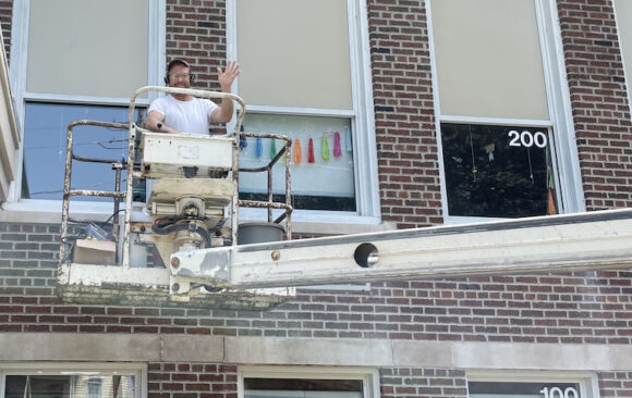 Mr. Green working on School Windows